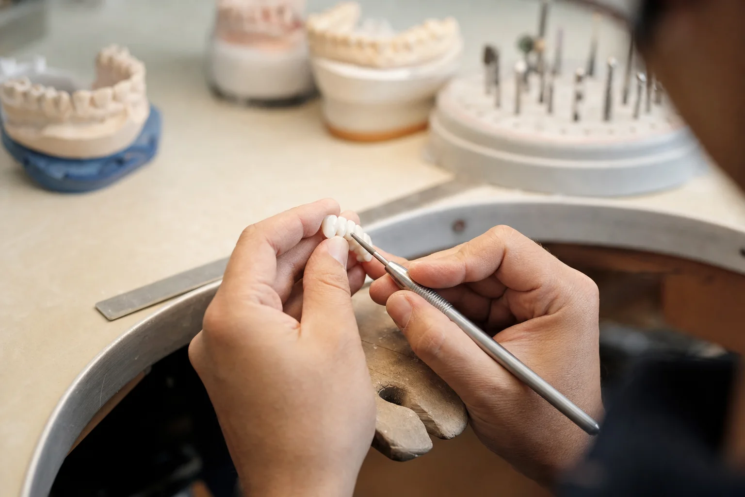 Technician hand-finishing a ceramic restoration at a local Perth dental laboratory, Prime Lab Dental Studios